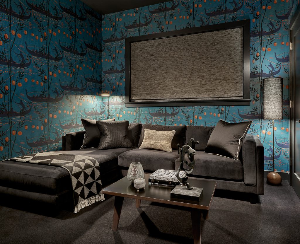 Adventurous Home black couch blue walls