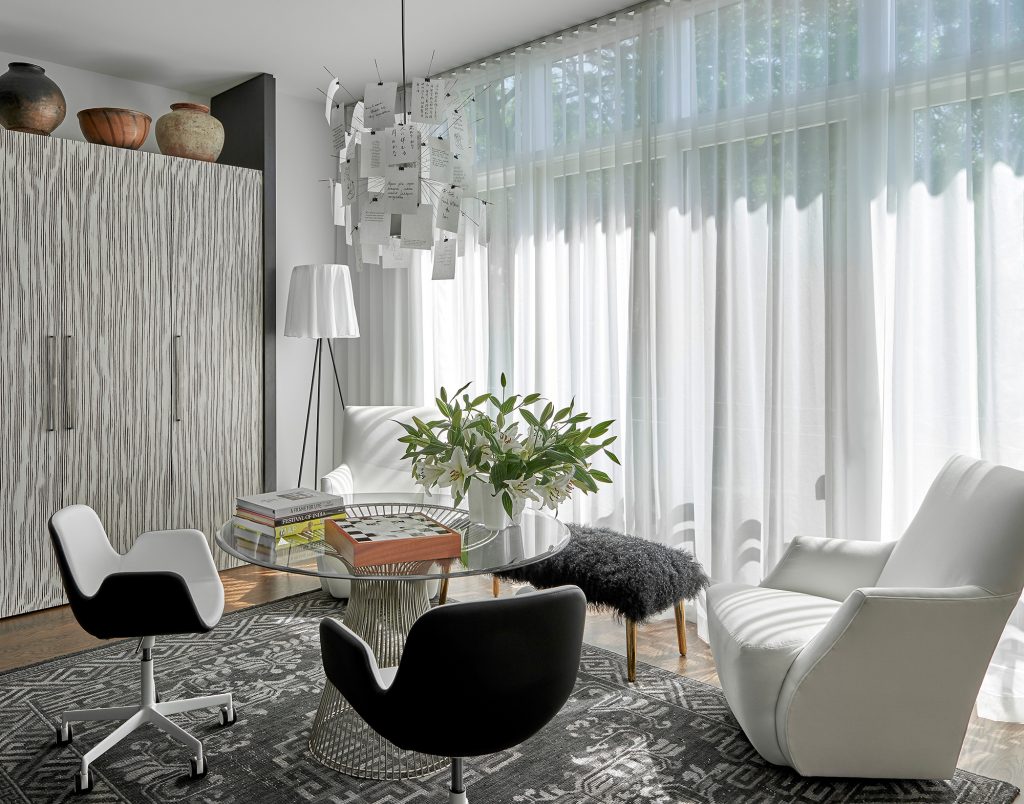 Adventurous Home white chair, glass table and curtains